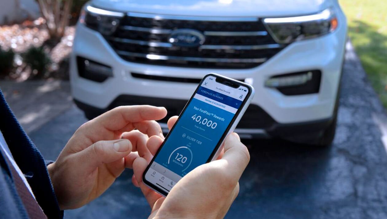 Hands holding phone with FordPass Rewards