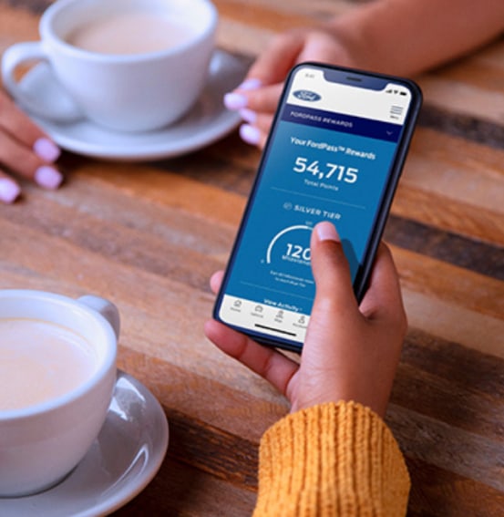 Person checking Ford Rewards on a phone
